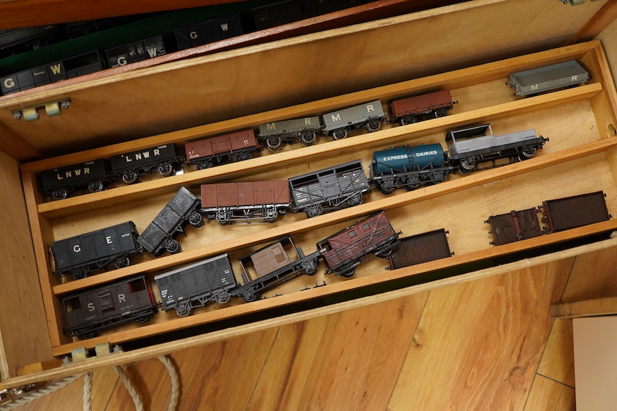 130 items of EM gauge model railway rolling stock contained within three handmade fitted wooden cases, two with removable trays, comprising three locomotives; an SR class 700 0-6-0 tender locomotive, 693, an SR 0-4-0T, 7
